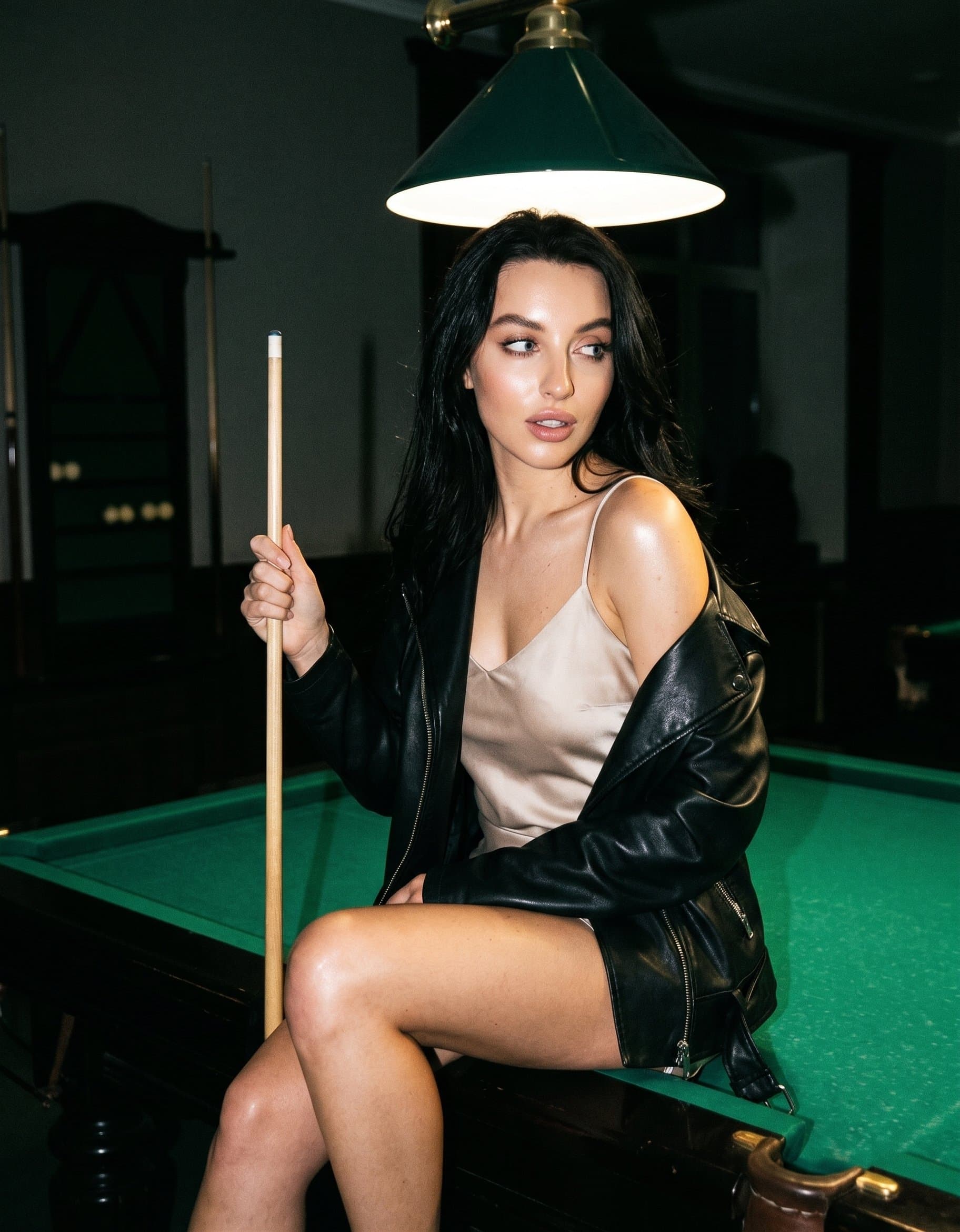 The character is playfully sitting on the wooden e