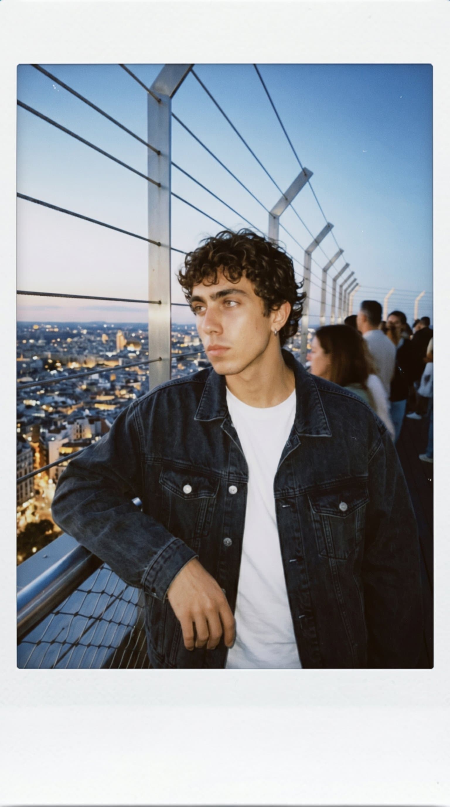 man gazing at a cityscape from a rooftop, Candid I