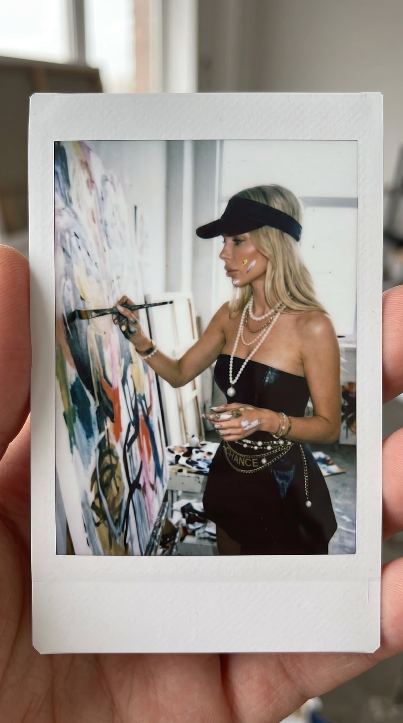 woman painting on a large canvas, Candid Instax Mi