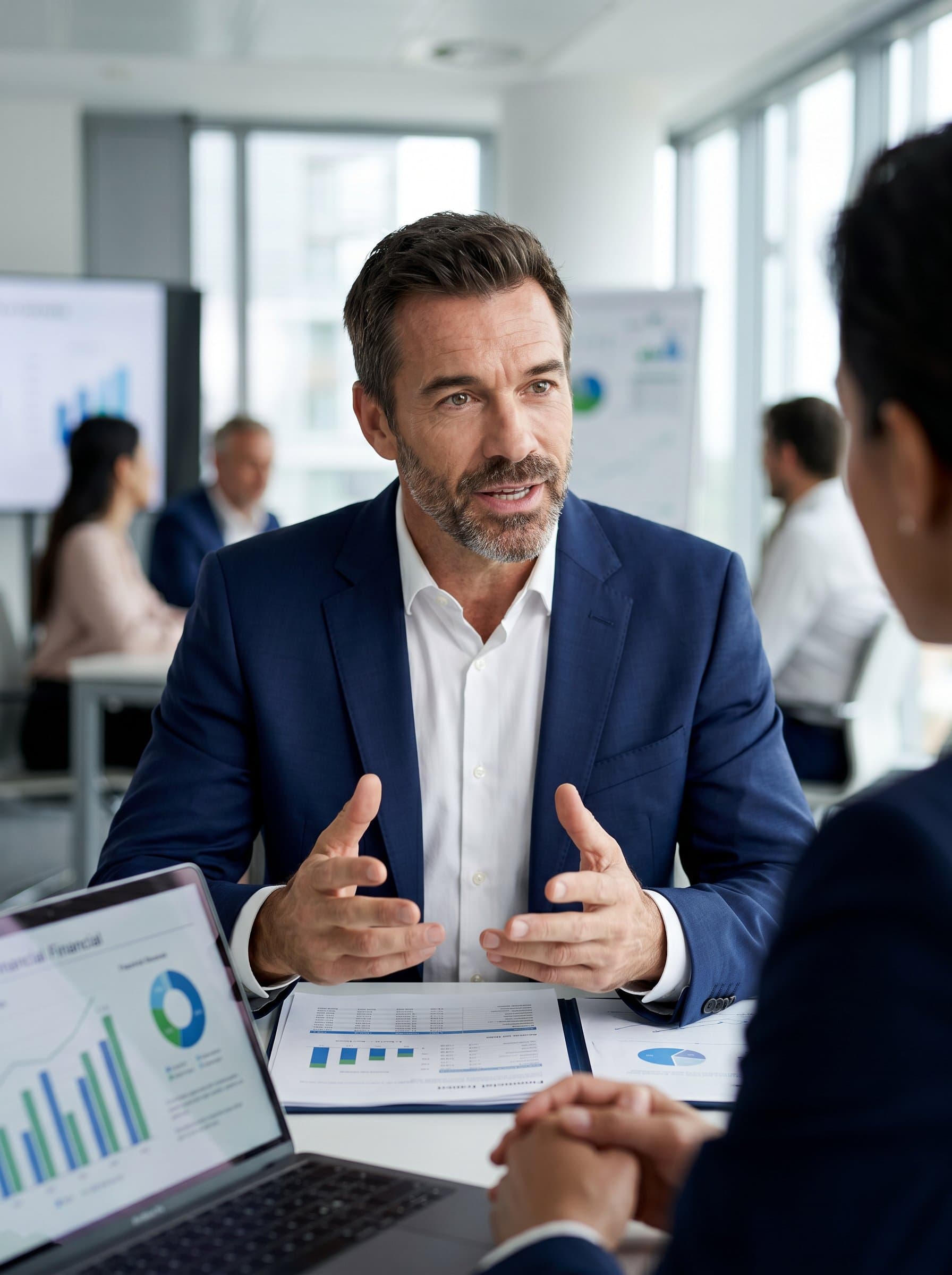 captured mid-discussion, with an out-of-focus meeting room setting behind, illustrating a proactive and communicative style essential in financial advisement.