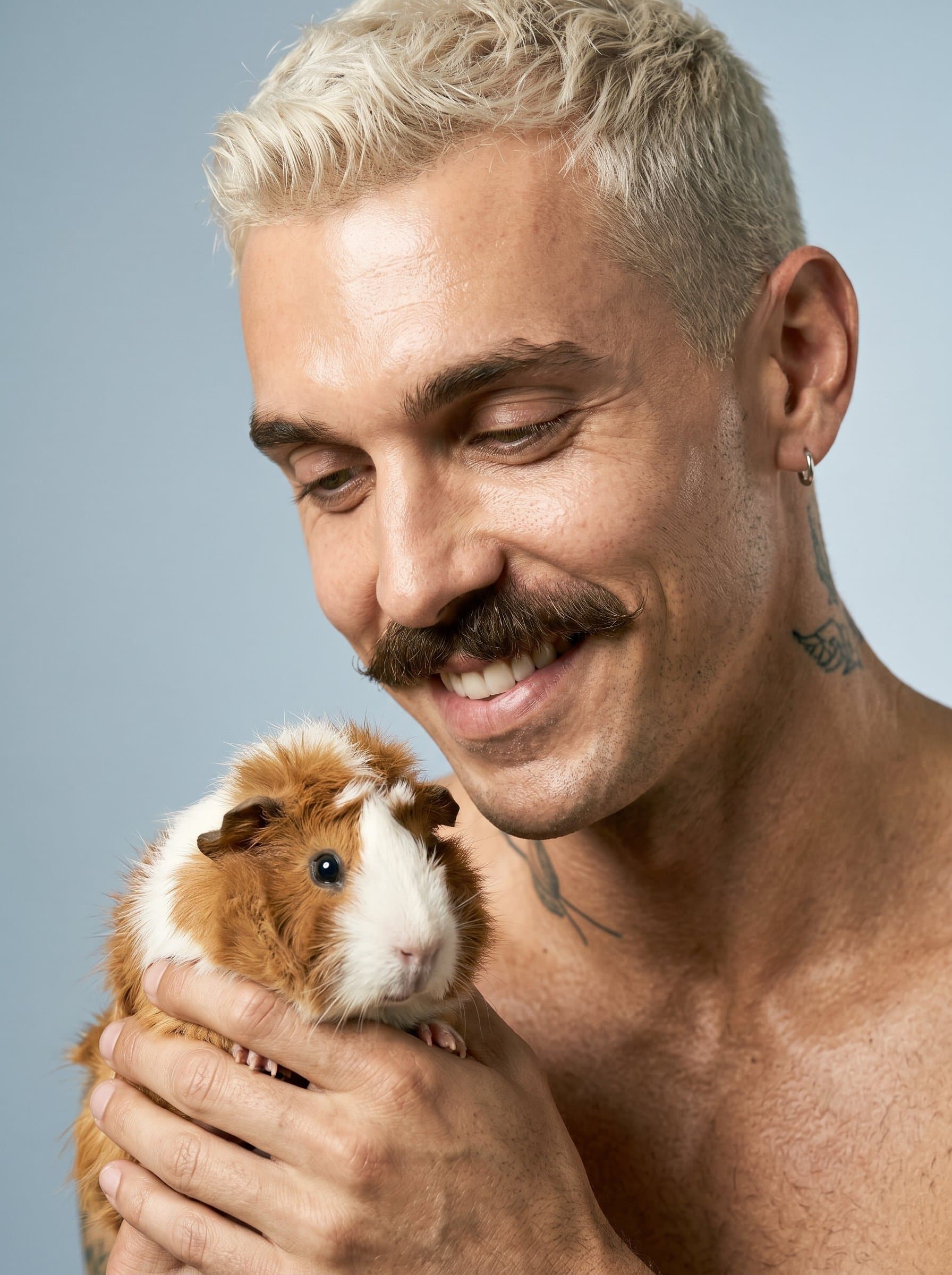 Close-up headshot of holding a guinea pig with a gentle smile. The soft, natural lighting and plain background highlight their nurturing side, suitable for any veterinary-related digital content.