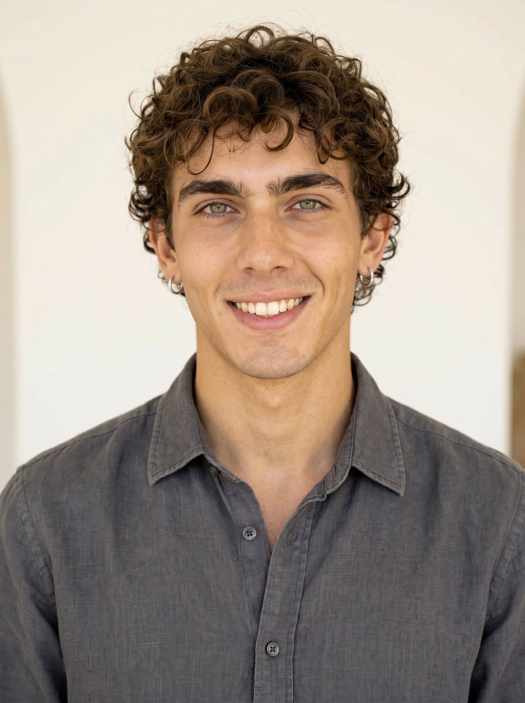 Casual Confidence in a author headshot. The author wears a relaxed and genuine smile, with a softly blurred white backdrop enhancing the open and friendly vibe.