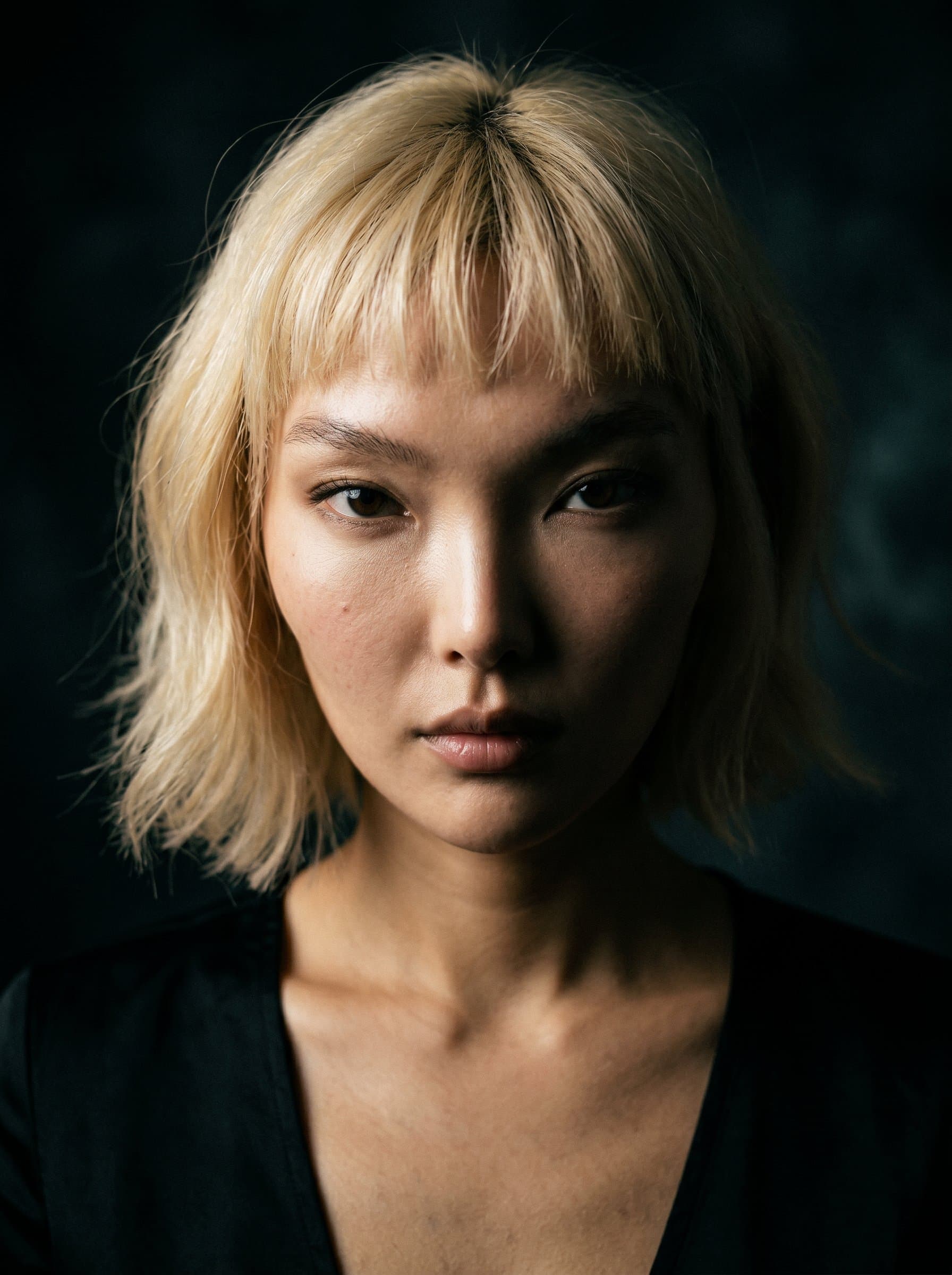 headshot focusing on Dramatic Impact. Author's intense gaze commands attention, set against a deep, shadowy backdrop. Adds a sense of mystery and intrigue.