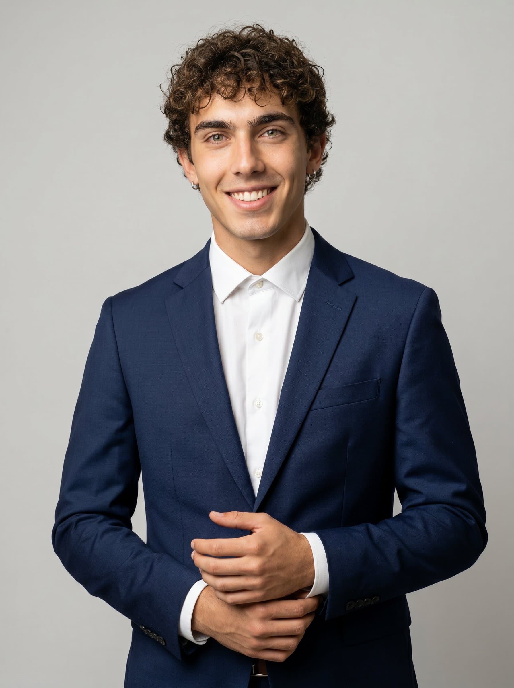 standing by a neutral backdrop, hands gently clasped, ready to listen and engage. A tailored suit and kind eyes depict the perfect blend of professionalism and empathy for a psychiatrist's headshot.