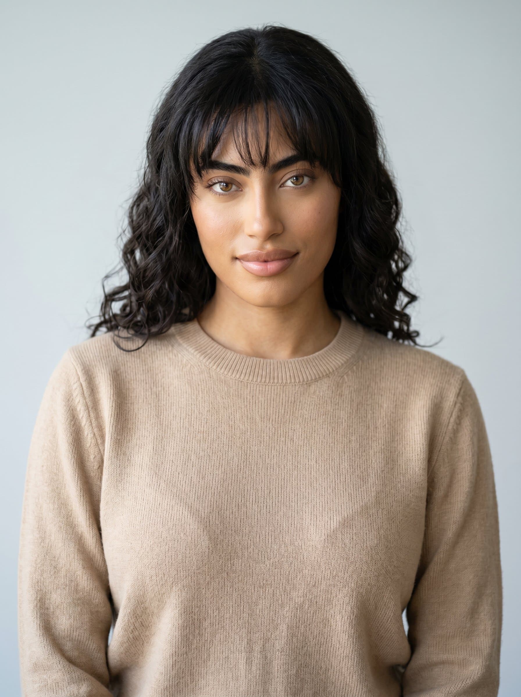With a minimalist background, 's headshot features them in a classic crewneck sweater. The simplicity highlights their versatility and adaptability in the dynamic world of city reporting.