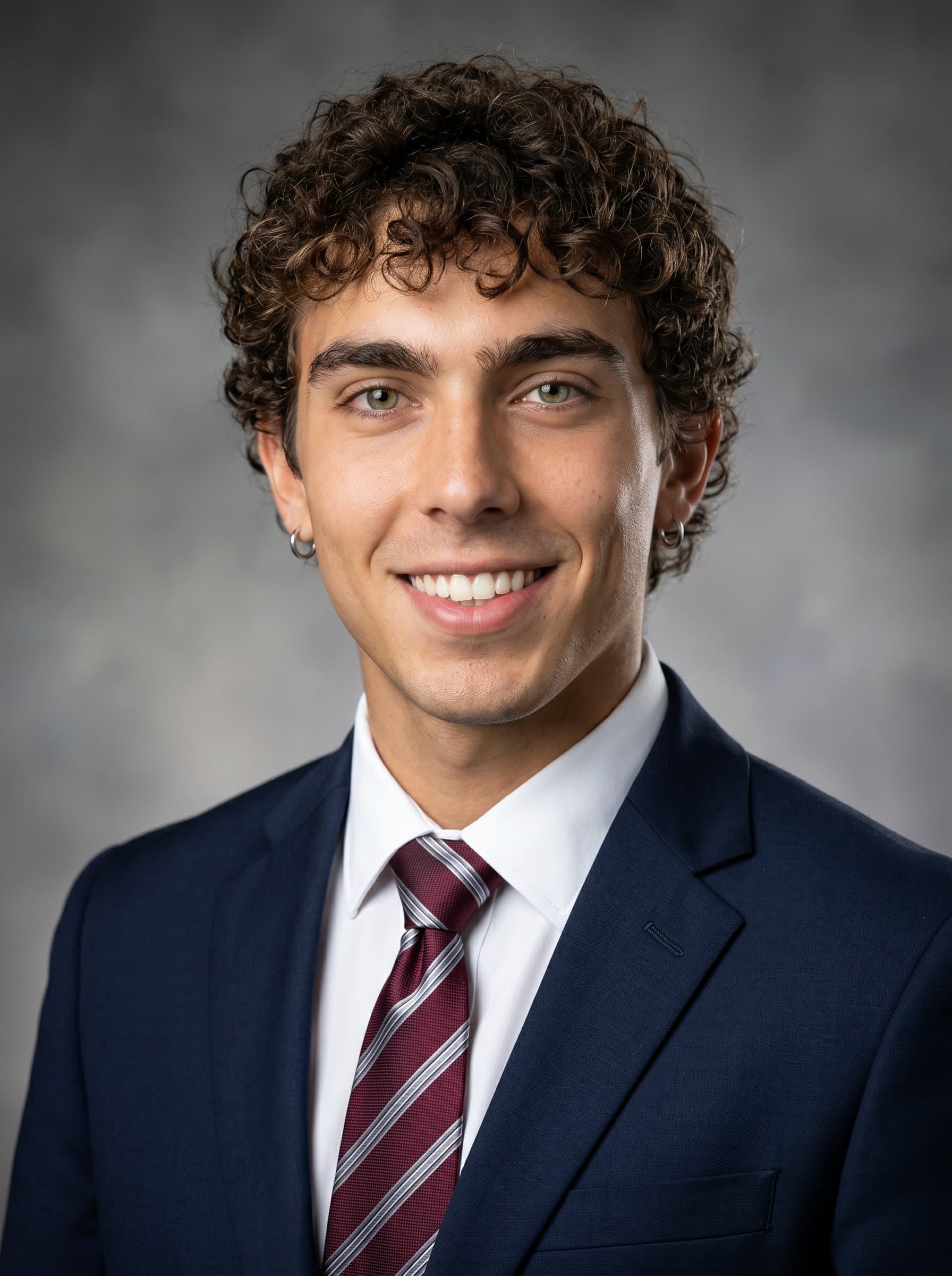 Headshot of wearing elegant professional attire. A clear, neutral background with subtle lighting brings out facial features, creating an image perfect for a TV news anchor.