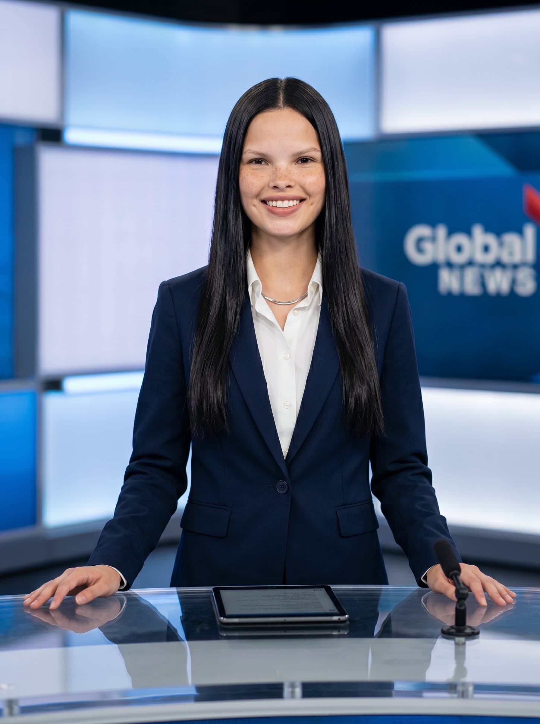 stands confidently, dressed in professional wear. A clear background and nuanced lighting create a polished, trustworthy news anchor image.