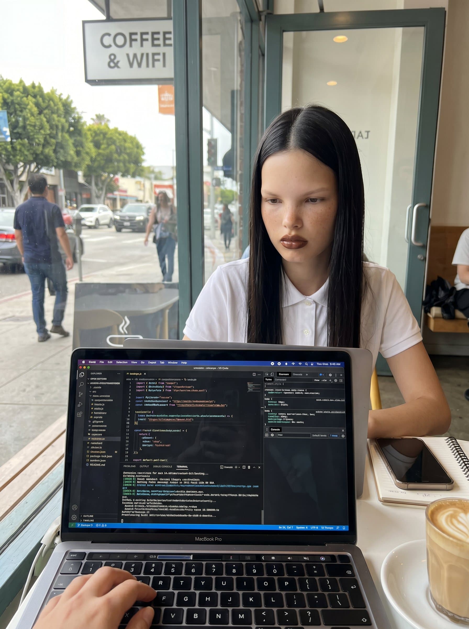 beside a coffee shop window, laptop open, accentuating the mobile and flexible work style of contemporary web developers.