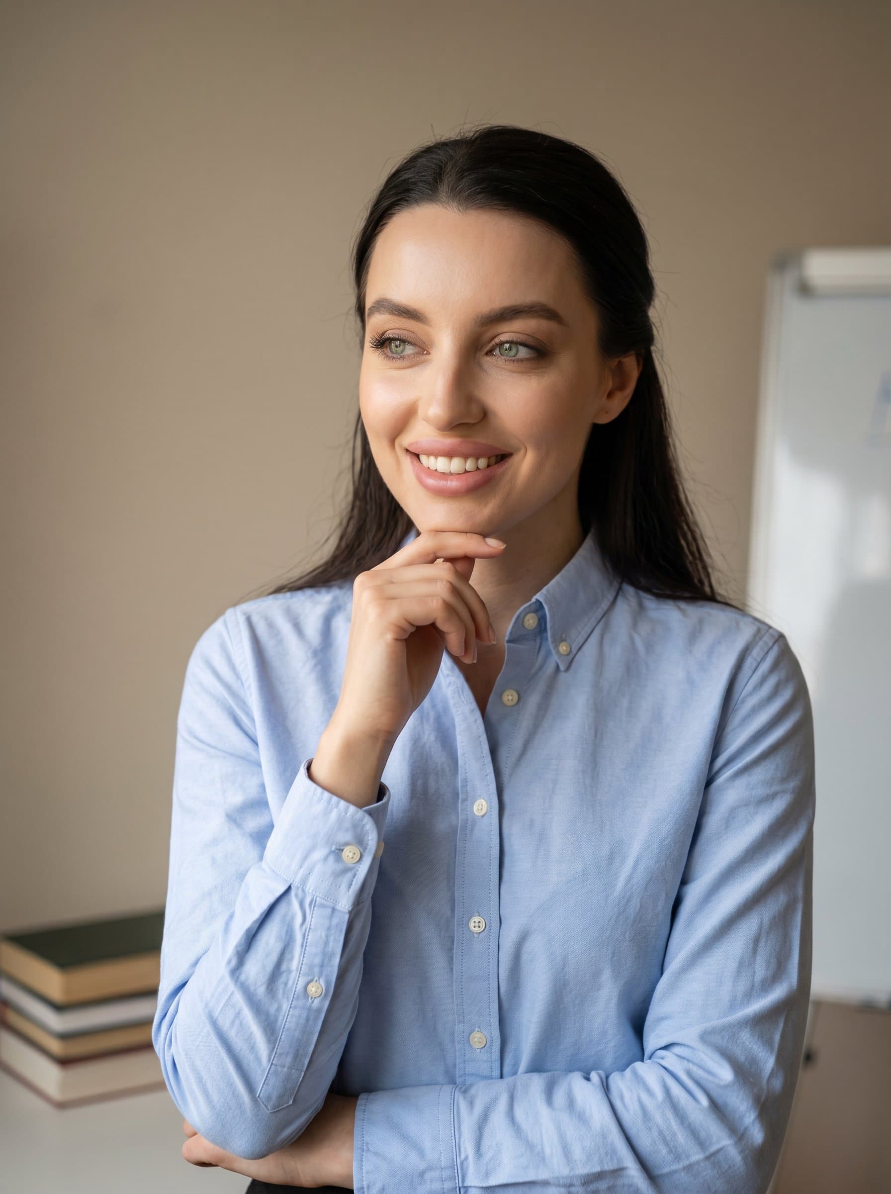 Photograph a tutor with a thoughtful, inspiring expression, wearing a classic button-down shirt. The background is a simple, muted tone, focusing on their enthusiasm and credibility.