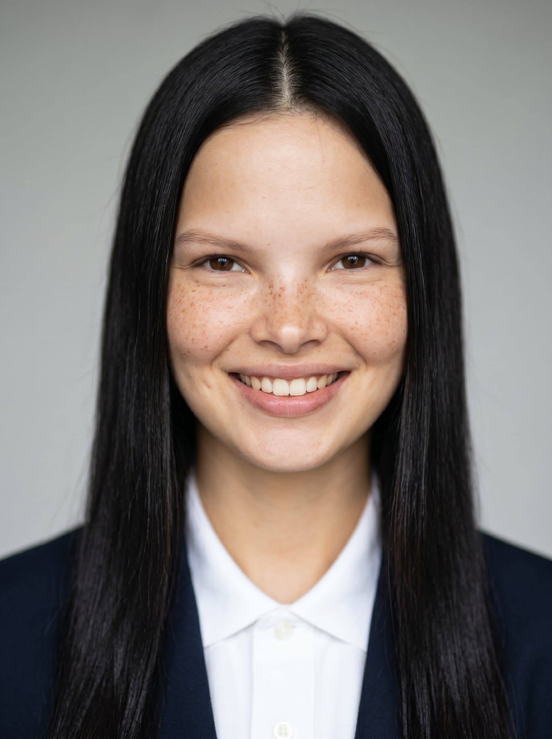 : Capture a headshot with a slight smile and natural expression, set against a neutral backdrop to communicate approachability in a politician's campaign imagery.
