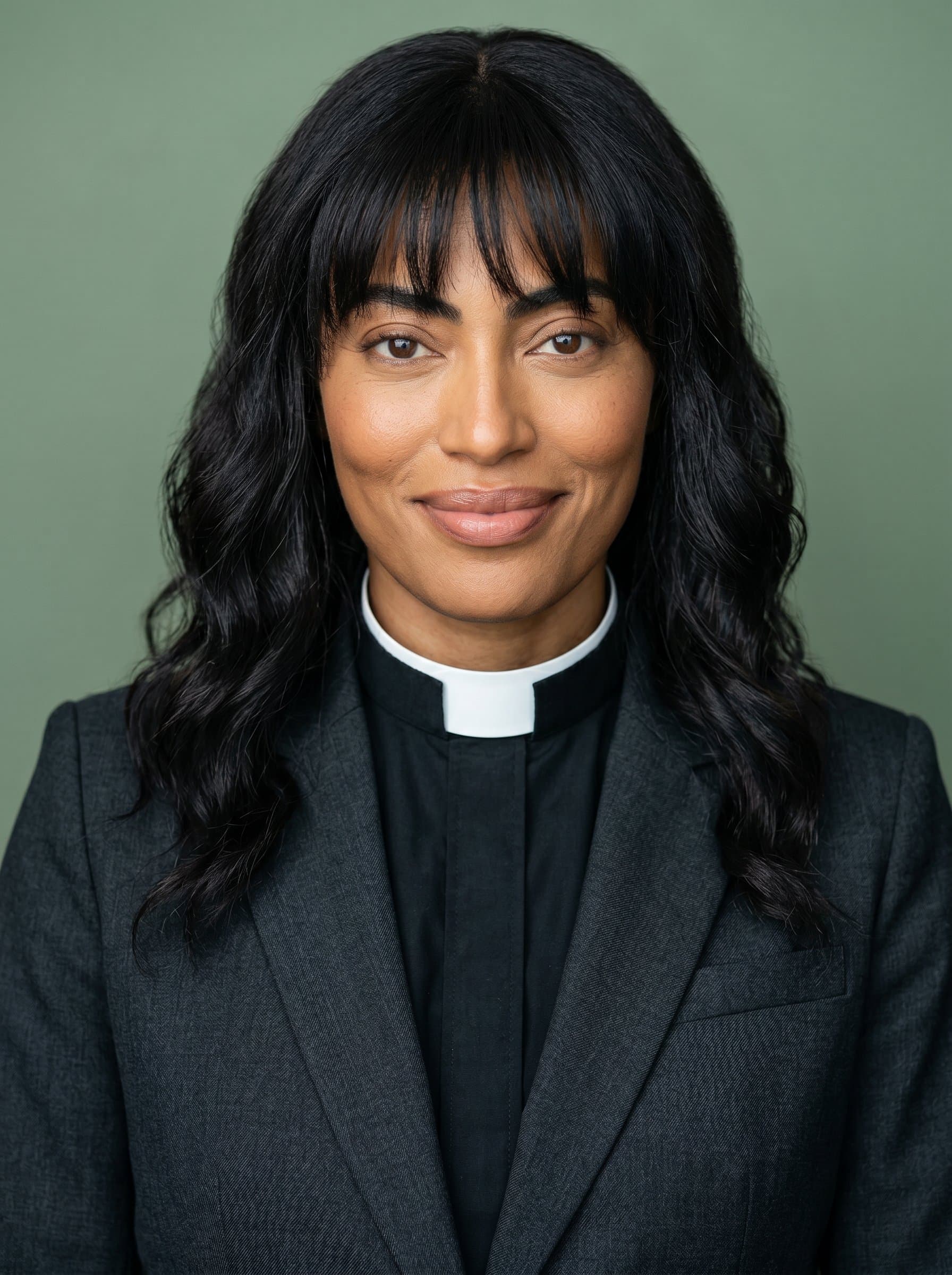 : A professional headshot of a pastor with a caring and wise expression, wearing a traditional dark suit, positioned against a muted sage green background, radiating comfort and steadfastness.