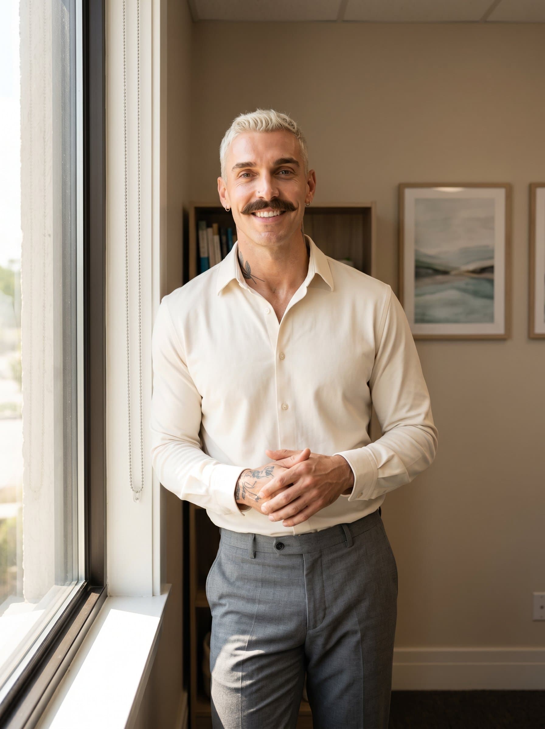 of a psychologist standing by a window, sunlight streaming in, with a backdrop of serene artwork and neutral colors, their expression calm and assuring, conveying openness and understanding.