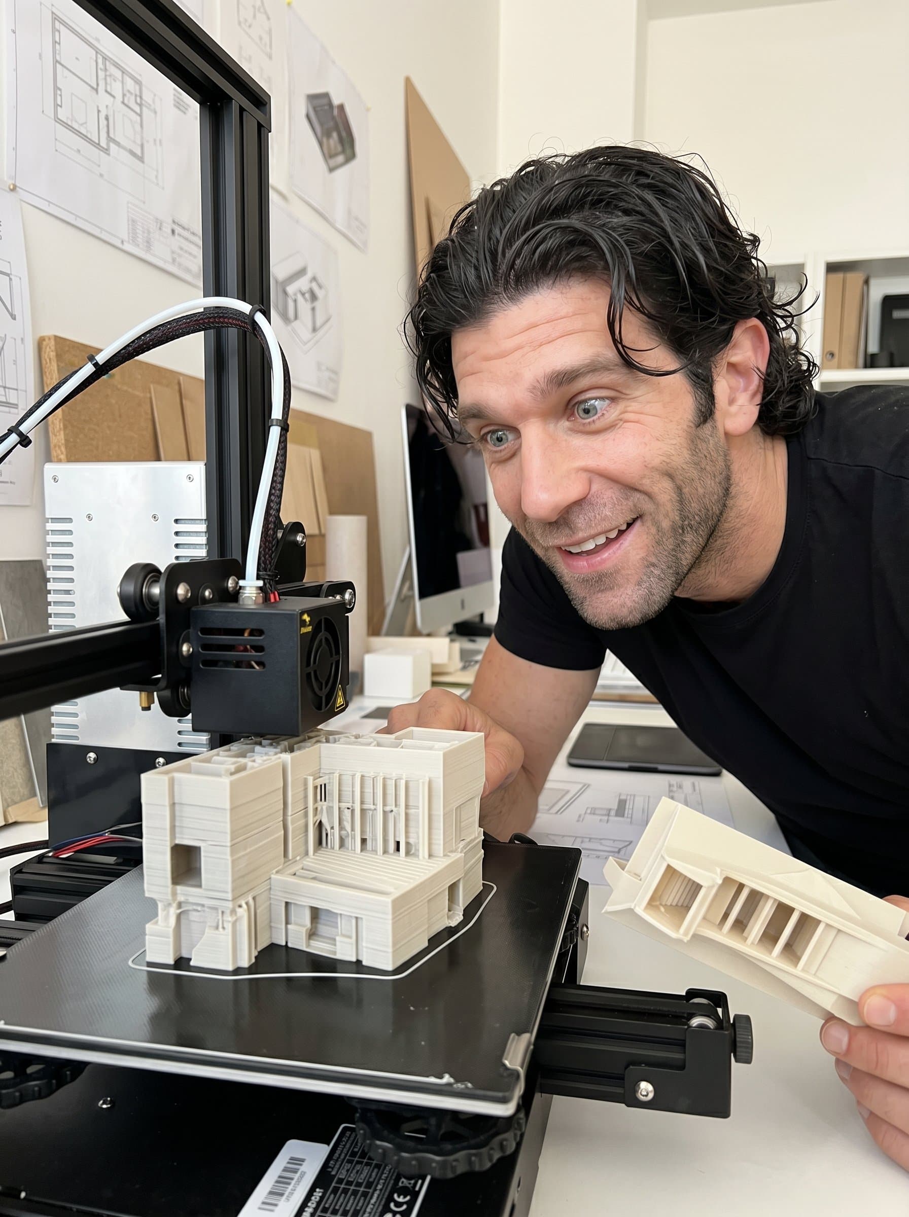 Photograph near a 3D printer producing design prototypes, with an expression of curiosity and delight. This setting emphasizes their engagement with emerging technologies and their impact on design practice.
