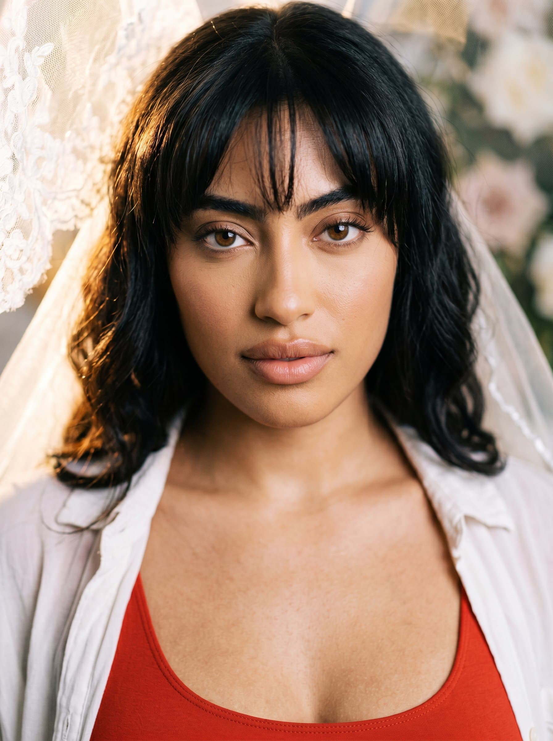 A close-up of with softly illuminated hair and expressive eyes. The studio lighting is dramatic yet gentle, evoking a sense of intimacy and passion—the core of capturing wedding memories.