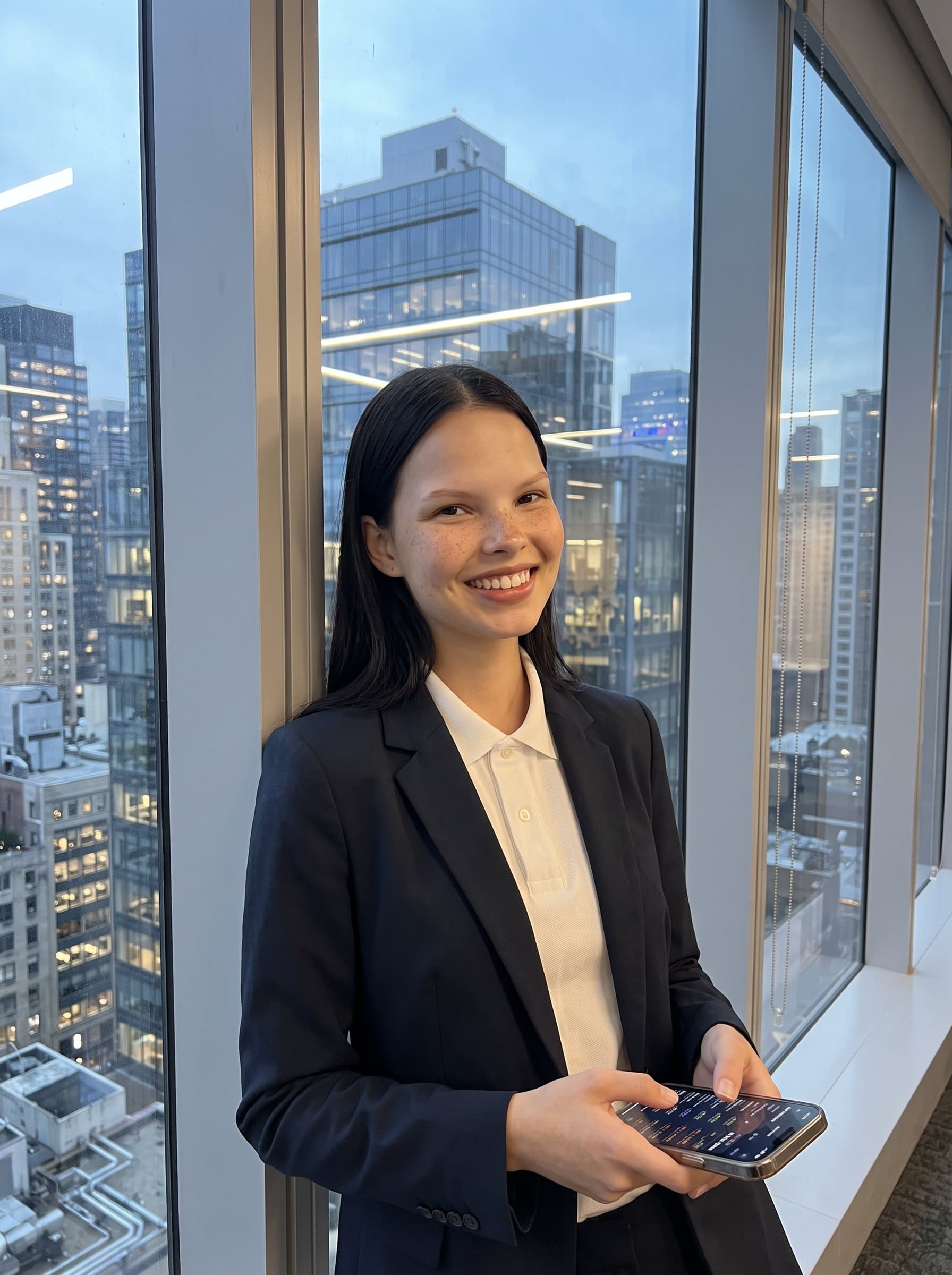 framed by cityscape views from a high-rise office window, conveying an urban tech vibe. Their smart-casual attire combined with an open-minded expression highlights a modern entrepreneurial spirit.