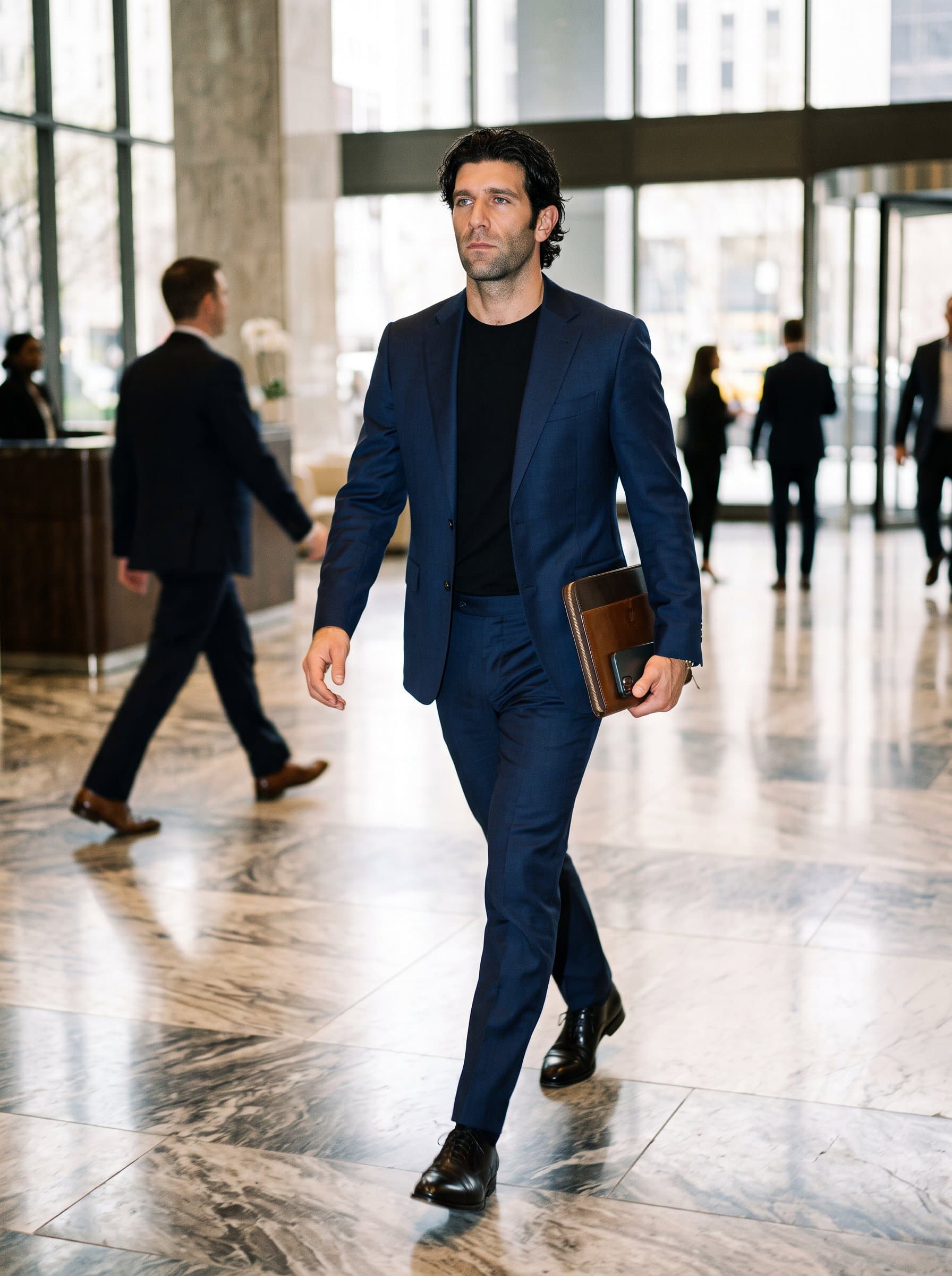 A candid shot of walking through a marble-floored lobby, capturing movement and purpose. The setting and their confident stride hint at leadership.