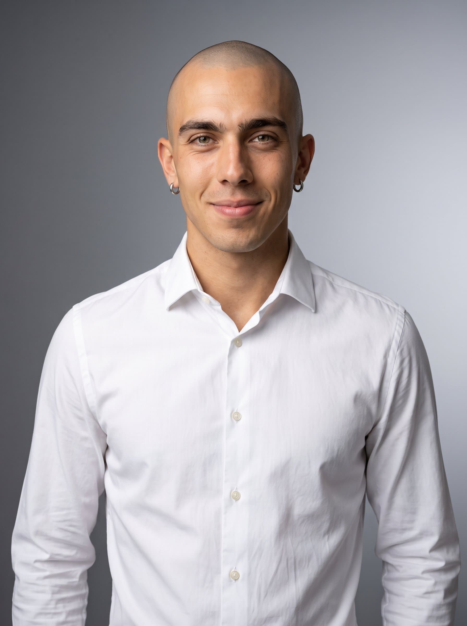 man with a shaved head and kind eyes, wearing a crisp white shirt. Background is a subtle gradient from light to dark grey, highlighting leadership qualities and a welcoming presence.