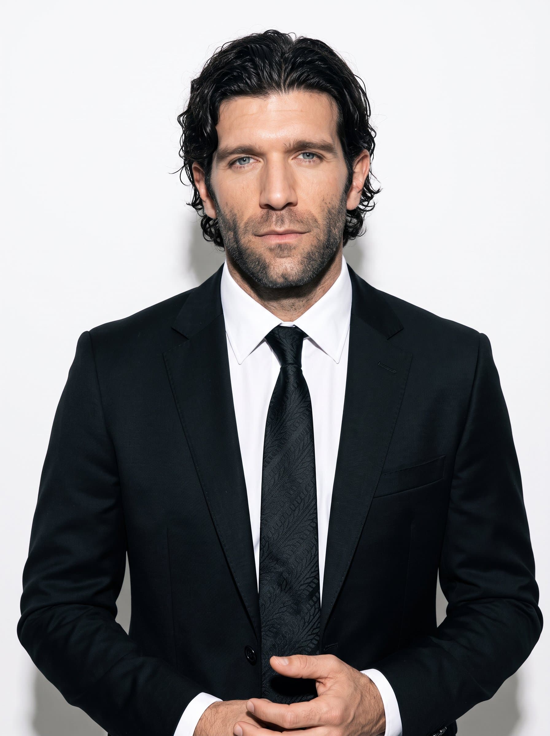 : Capture a professional dressed in black with a subtle tire tread pattern tie, set against a clean white background. Their poised expression suggests a deep understanding of automotive innovation.