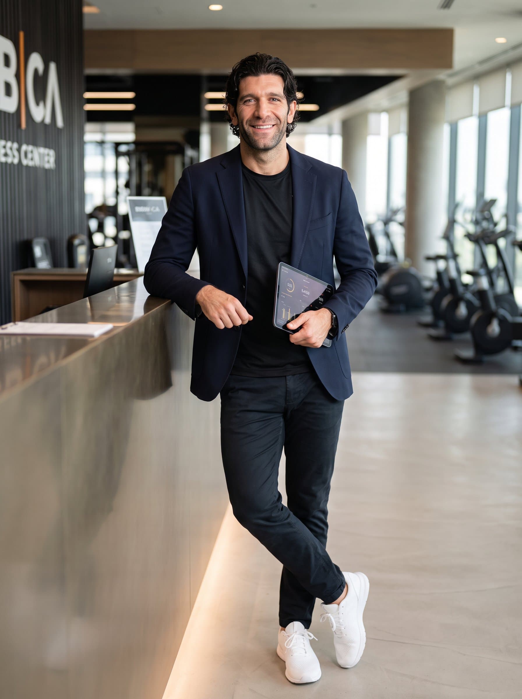 smiling confidently at the camera in a professional setting, wearing a blend of smart-casual attire with athletic elements, embodying the approachable yet authoritative presence of a fitness expert.