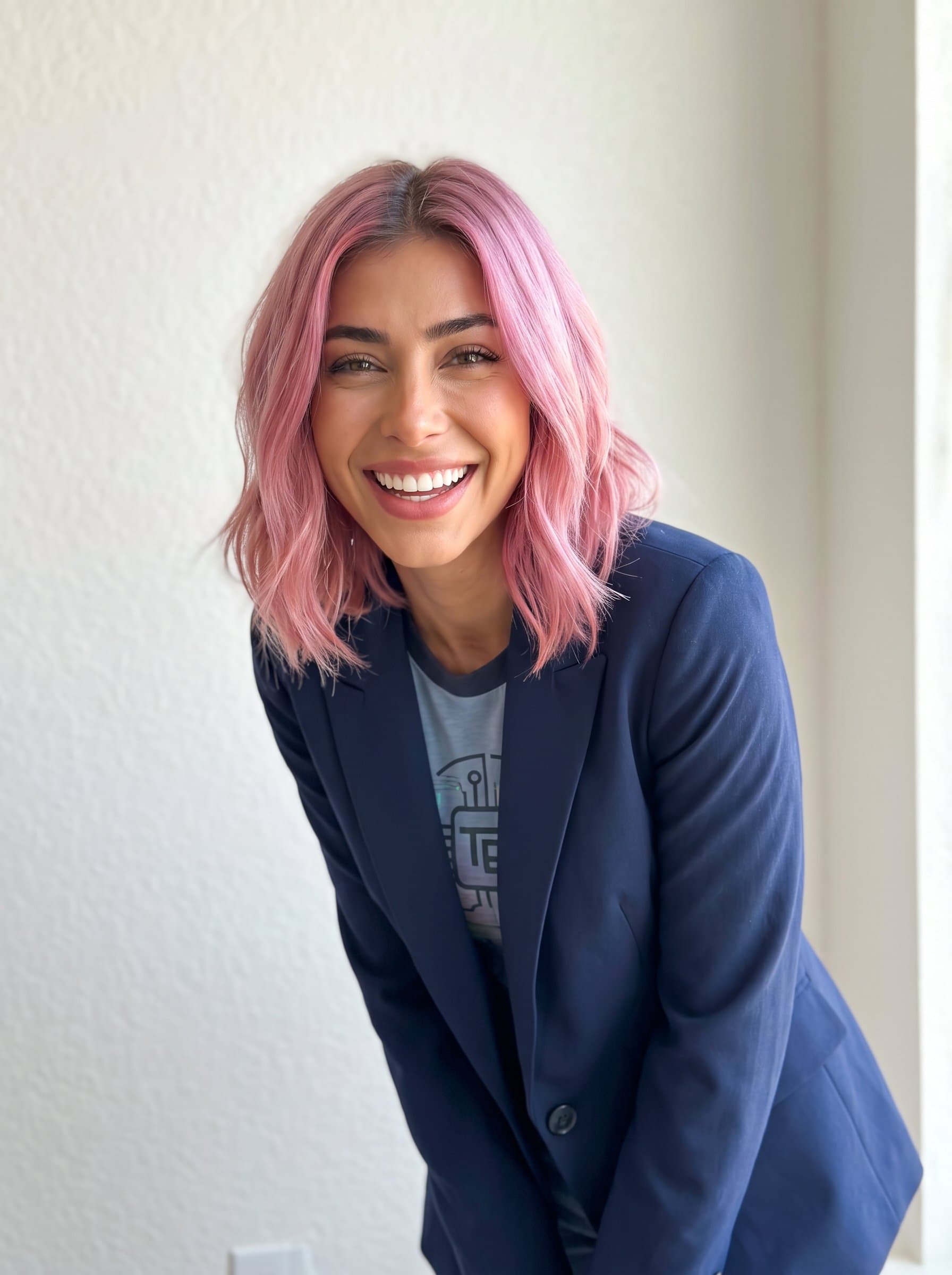 : Generate a dynamic, youthful headshot with a modern appeal. The woman is dressed in smart-casual wear, positioned against a lightly textured wall, highlighting creativity and enthusiasm for tech roles.