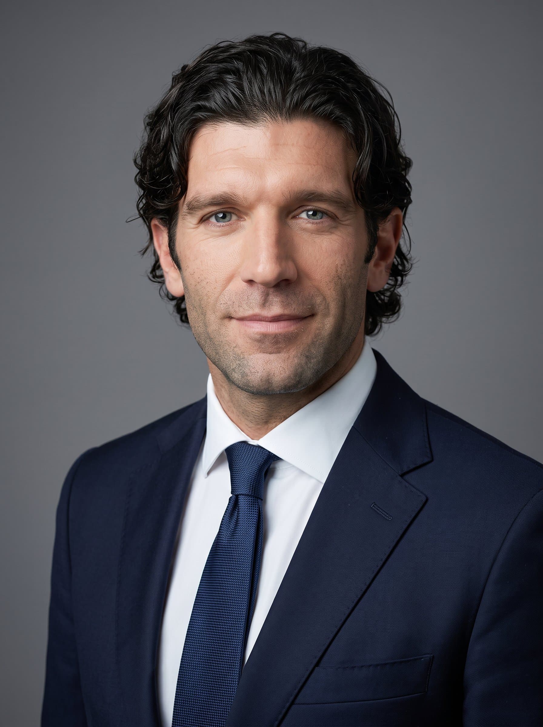 : Capture a corporate headshot with a sleek, monochrome background. The man's attire is formal, their expression serious yet inviting, tailored for a professional, executive presence on platforms like Twitter.
