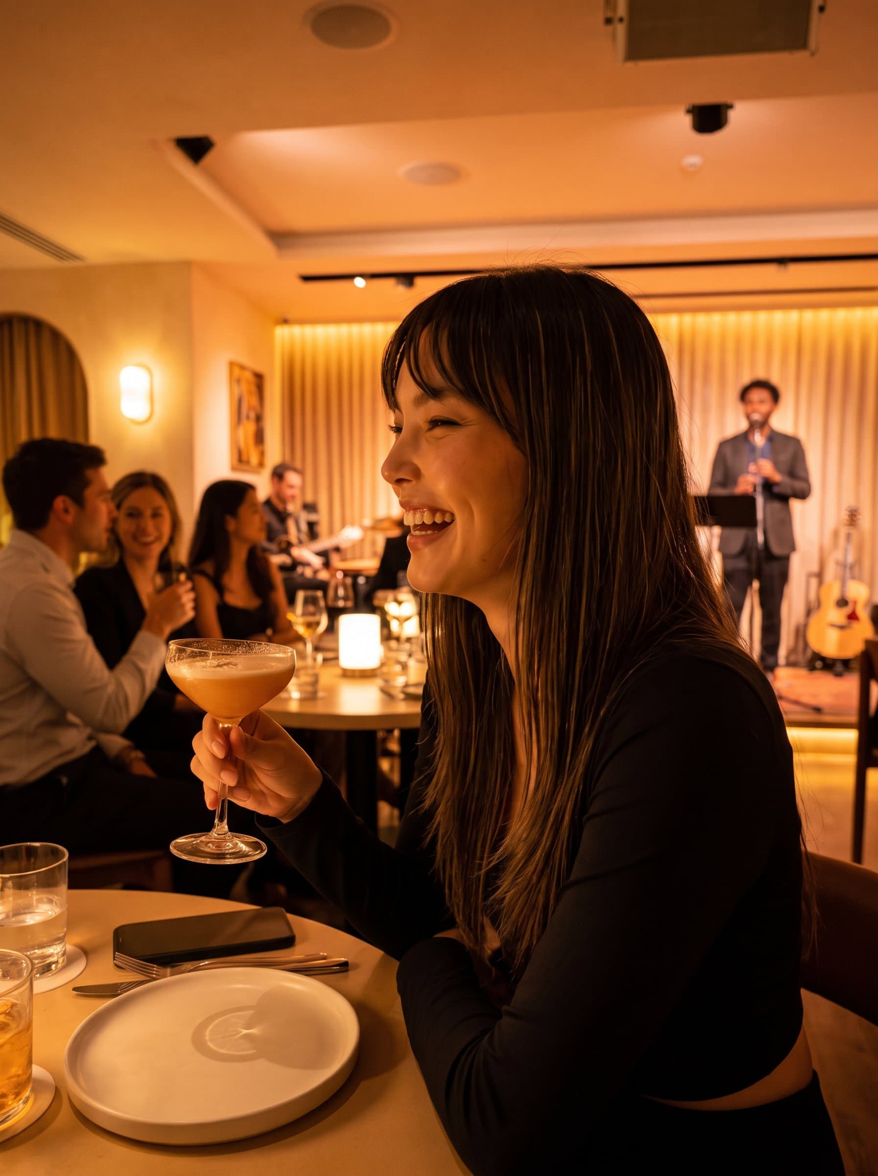Portray a in a lively music lounge, with soft lighting and a cheerful grin, suggesting enjoyment and approachability for an engaging OkCupid profile image.