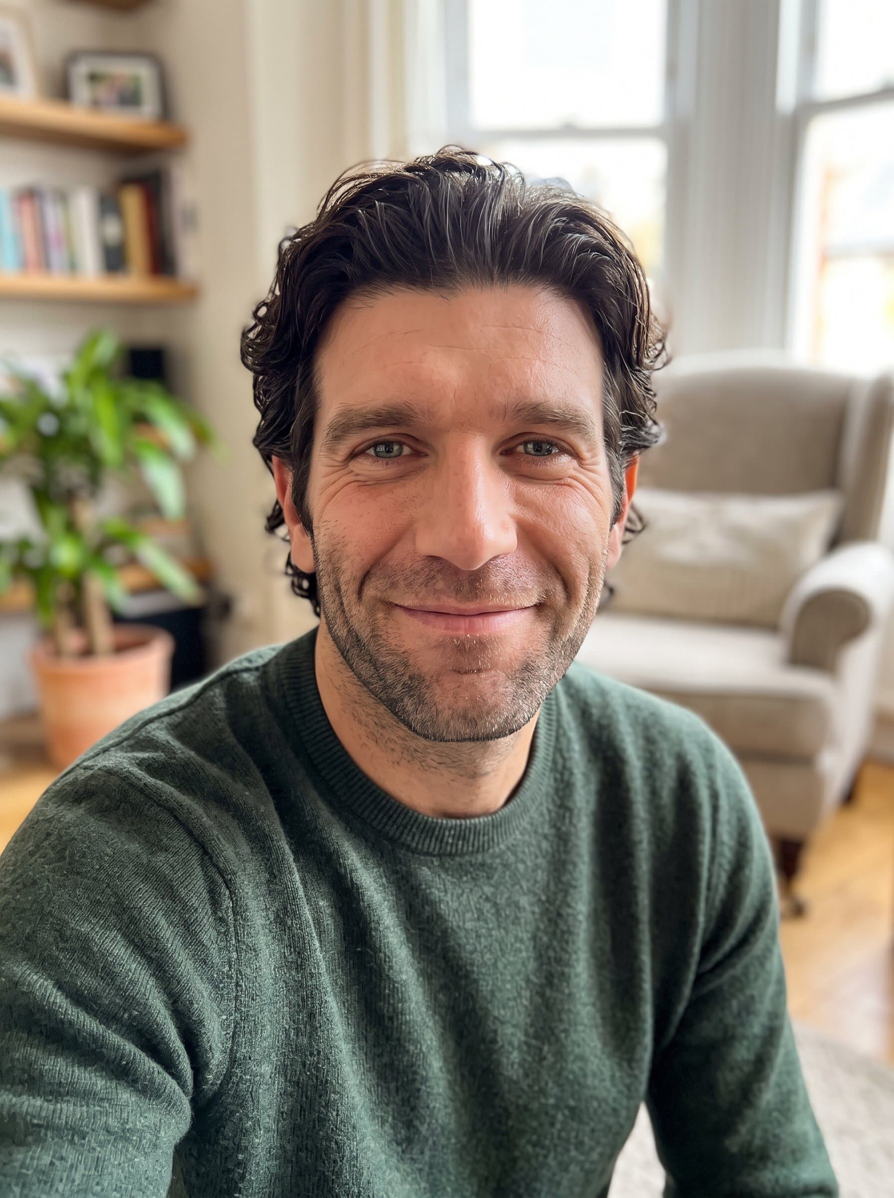 : Capture a Casual Charm headshot in a relaxed home environment, with soft lighting and a welcoming smile, perfect for a Match.com profile that invites others to connect authentically.