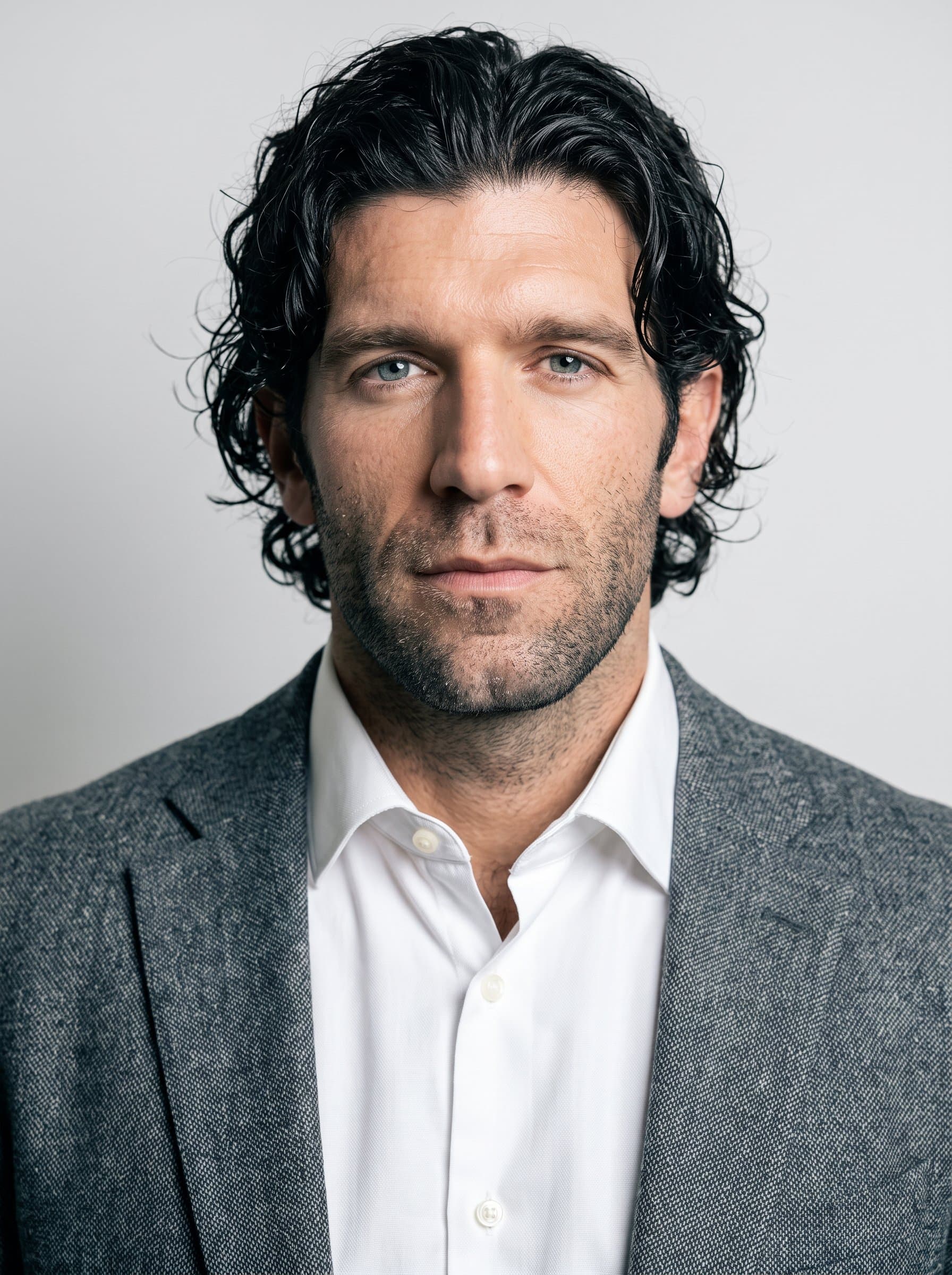 Illustrate a headshot where the man wears a tailored shirt, looking directly at the camera. The simple white background brings out their steady gaze and assured presence, perfect for online avatars.