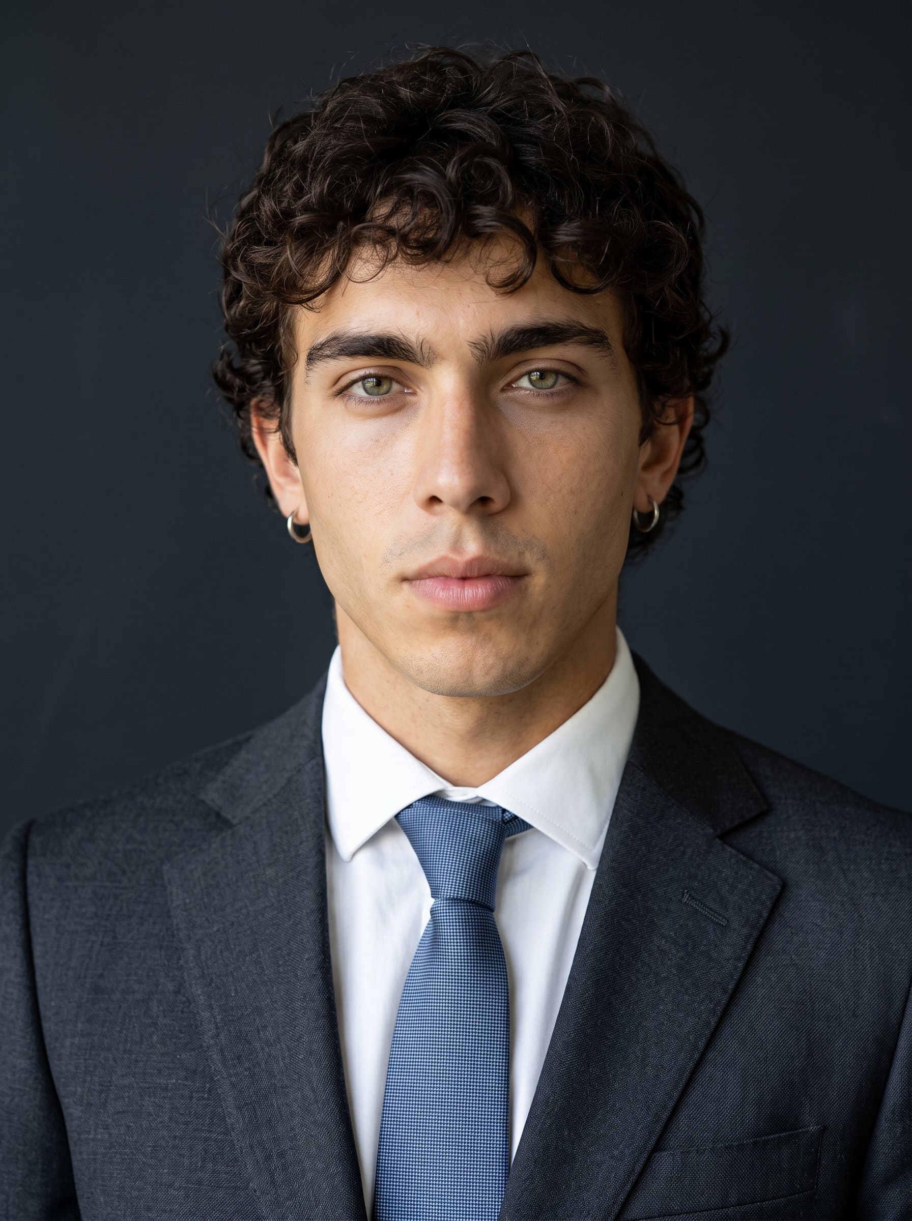 Construct a headshot with a dark, neutral background to emphasize facial features. The attire is formal, with a serious yet approachable expression, ideal for legal or financial sectors.