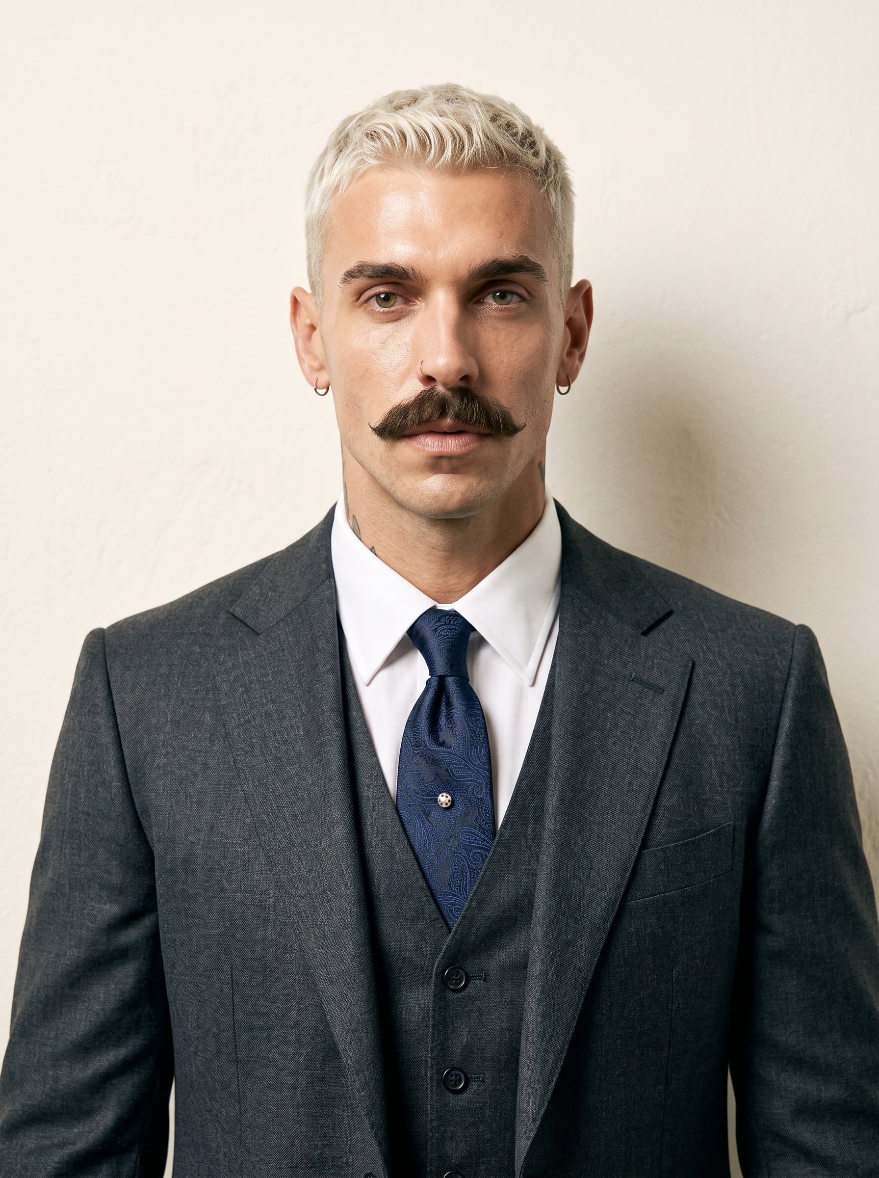 Generate a sophisticated AI headshot of dressed in formal attire, with a composed demeanor and an ivory background, suitable for an elegant business card.