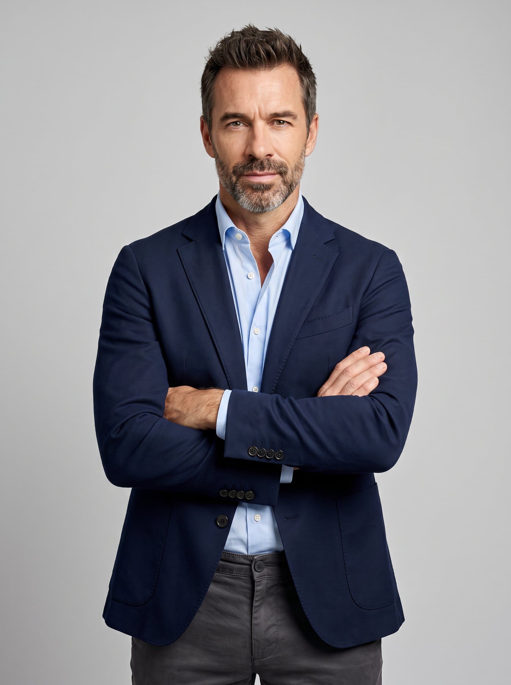 Capture in a business casual outfit with a confident expression, against a neutral grey background, offering flexibility for a unique business card style.