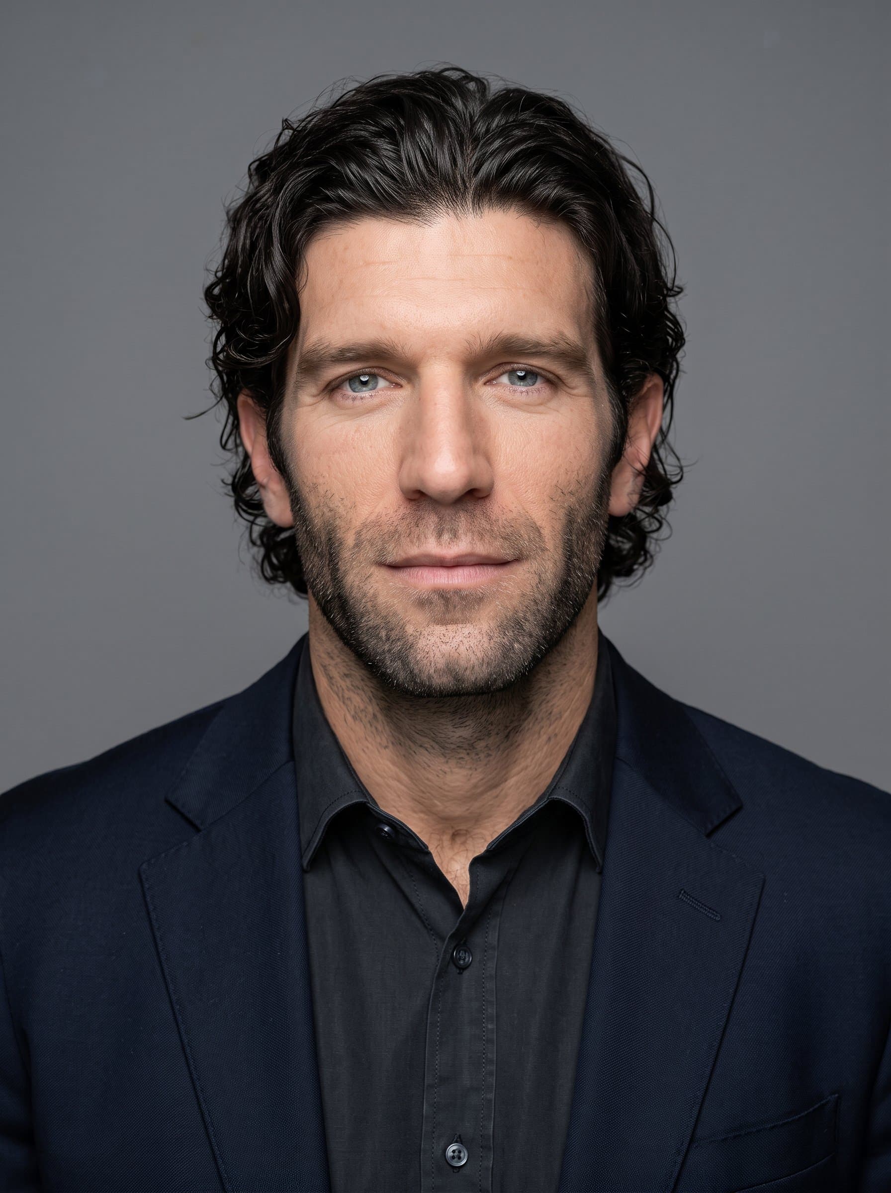 : Fabricate a photorealistic headshot for an AI employee. Achieve a centered composition with a gender-neutral man, using subdued lighting and a simple backdrop for a modern tech company appeal.