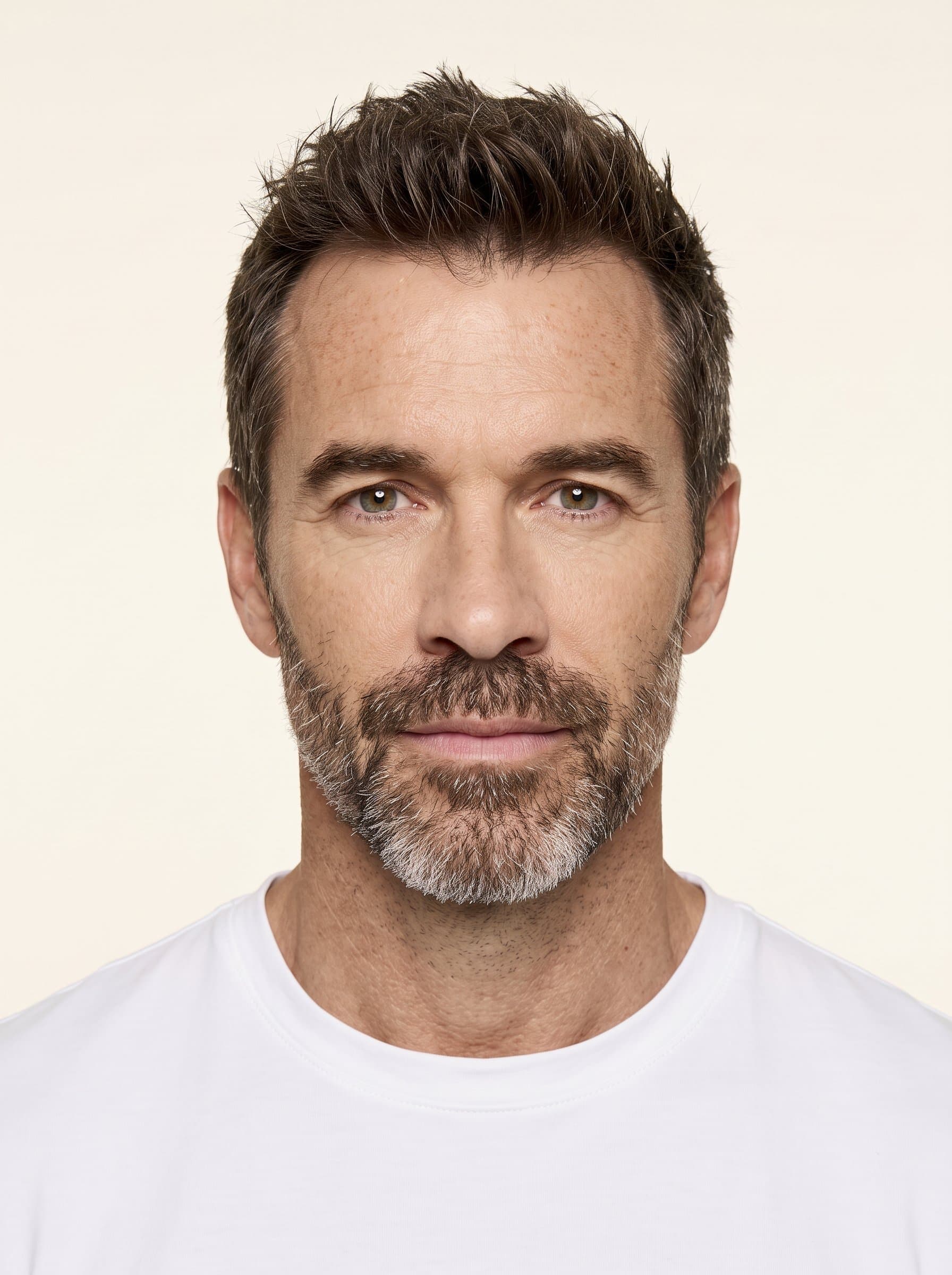 Render a image depicting a clean and clear view of the face. Use a soft ivory backdrop, ensuring compliance with international travel photo guidelines.